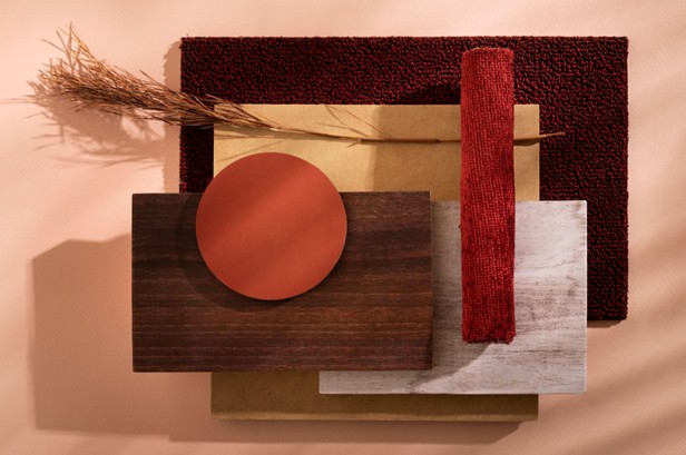 Interior mood board featuring dark timber, terracotta, burgundy bouclé, warm stone, and dried grasses: a palette that complements Jarrah furniture